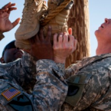 Staff Sgt. Reginald Alexander and Maj. Jonathan Gardner help a fellow Operational Contract Support Joint Exercise 2016 participants accomplish an obstacle course during OCSJX-16, March 24, 2016, at Fort Bliss, Texas. This exercise provides training across the spectrum of OCS readiness from requirements and development of warfighter staff integration and synchronization through contract execution supporting the joint force commander. Sgt. Alexander and Maj. Gardner are stationed at Fort Hood, Texas. (U.S. Air Force photo by Tech. Sgt. Manuel J.Martinez/Released)