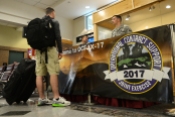 An OCSJX-17 exercise participant checks into the reception desk, March 14, 2017, at El Paso International Airport, Texas. Nearly 450 service members from all branches of the Department of the Defense and allied partners arrived at the El Paso International airport are participating in the Operational Contract Support Joint Exercise-2017. (U.S. Air Force Photo by Tech. Sgt. Chad Chisholm/Released)
